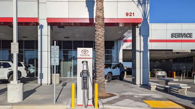 A Toyota dealership with an electric vehicle charging station.