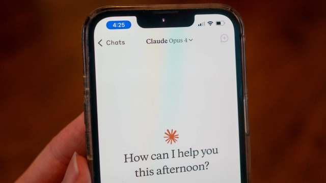 A smartphone screen displays a chat interface with a message asking, "How can I help you this afternoon?"