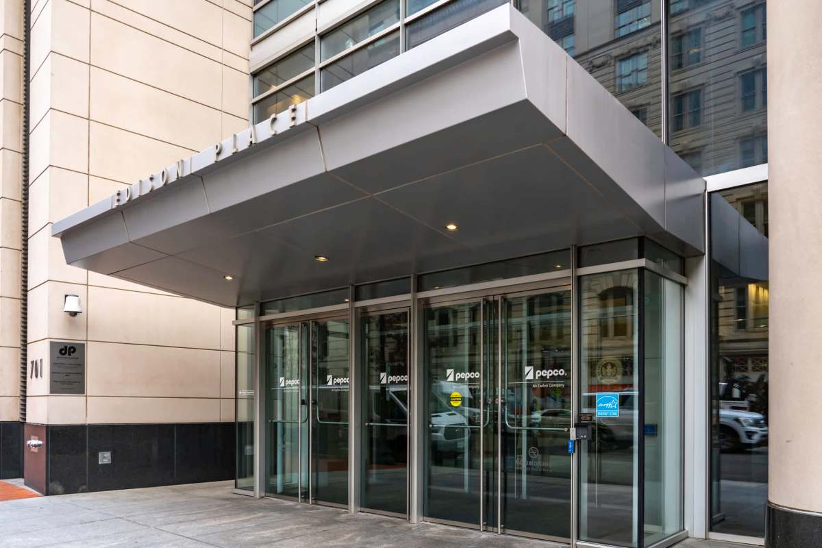 The entrance of Edison Place building with glass doors and signage for Pepco company.