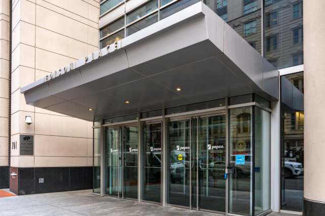 The entrance of Edison Place building with glass doors and signage for Pepco company.
