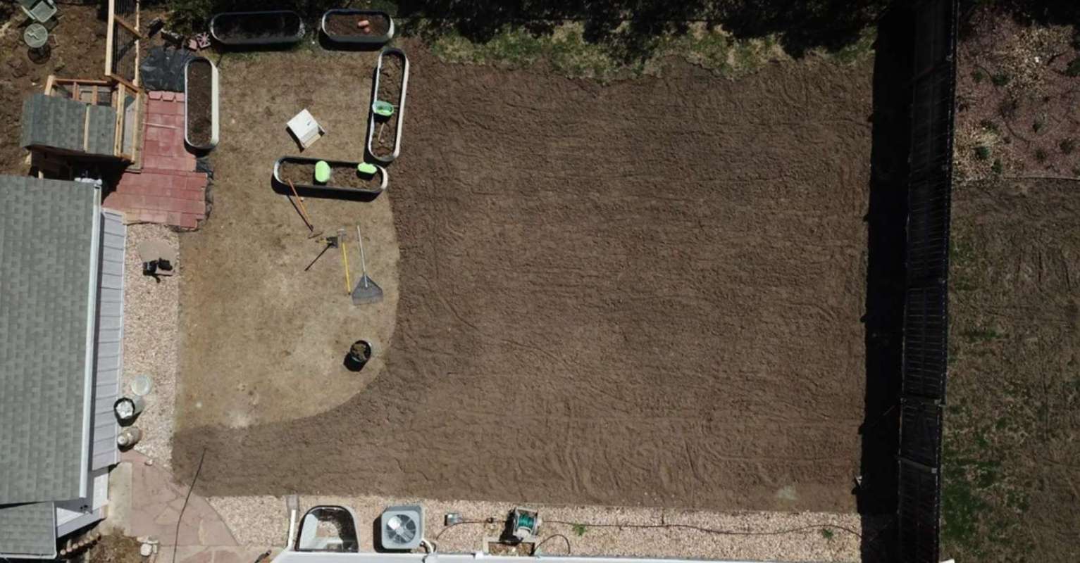 A backyard filled with dirt.