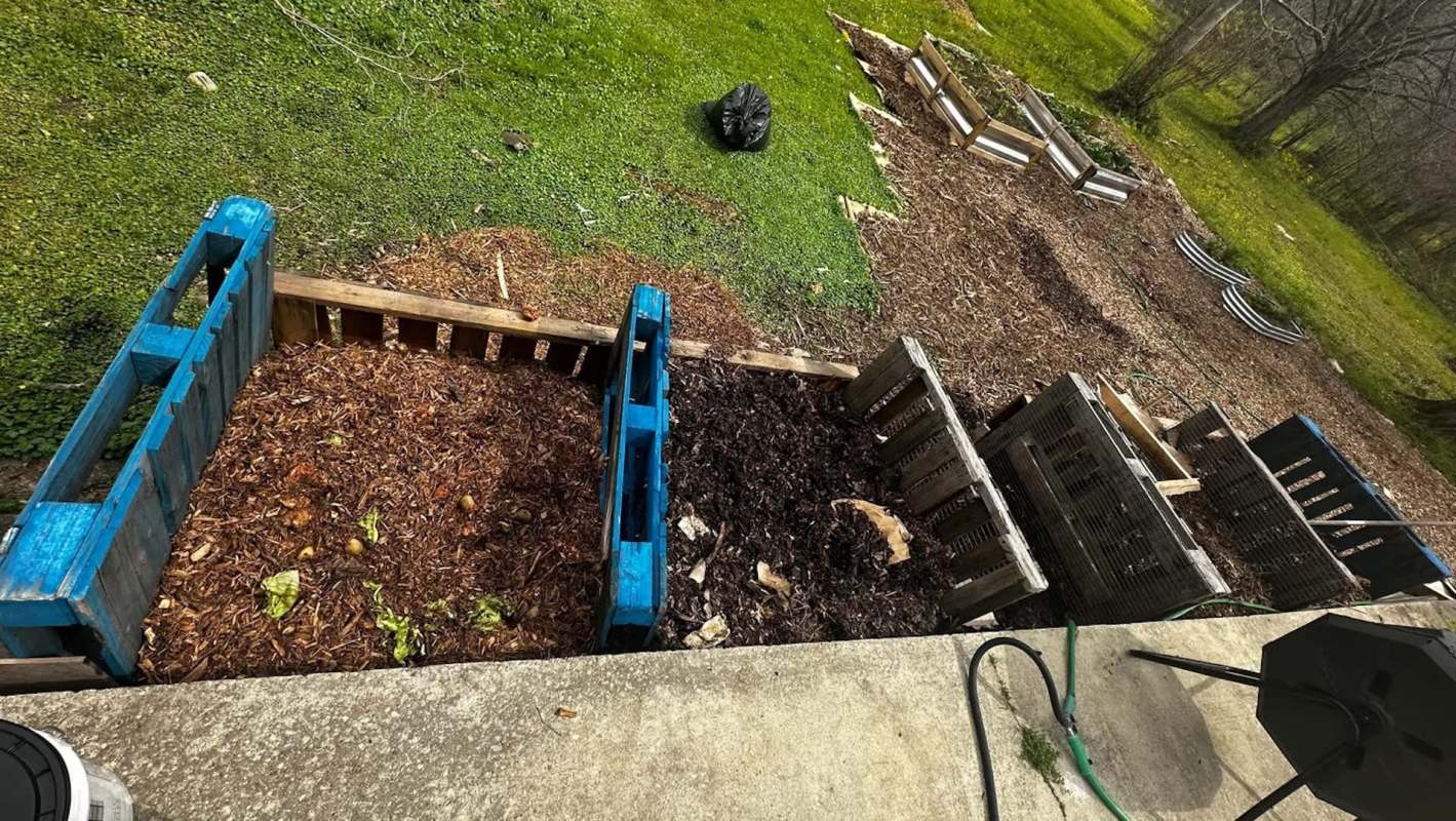 A composting area with wooden bins.