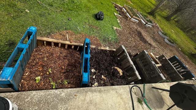 A composting area with wooden bins.
