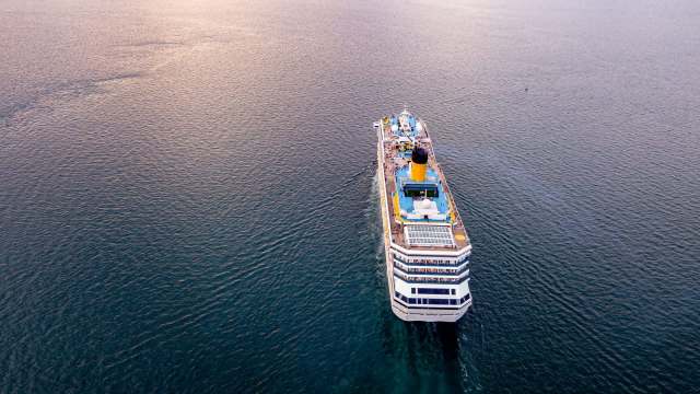 A cruise ship sailing through calm waters.