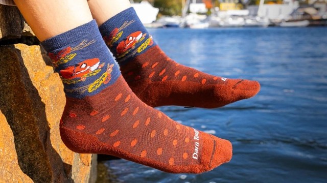 A pair of socks with fox and polka dot designs.