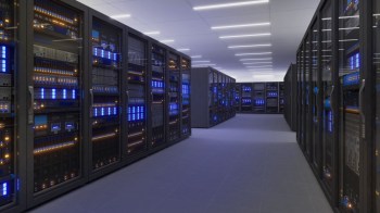 A modern server room featuring racks of servers with glowing blue and orange lights in a sleek, spacious environment.