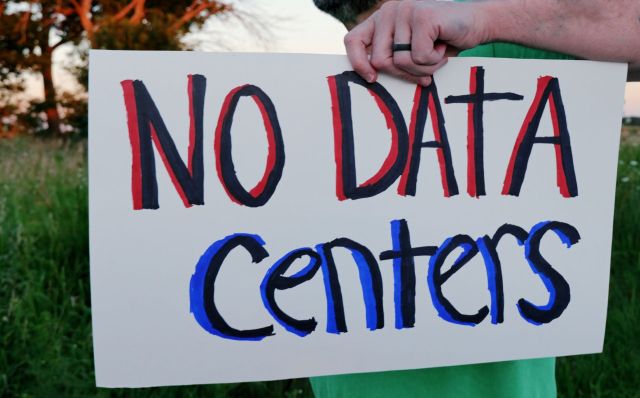 A protest sign reading "No Data Centers."