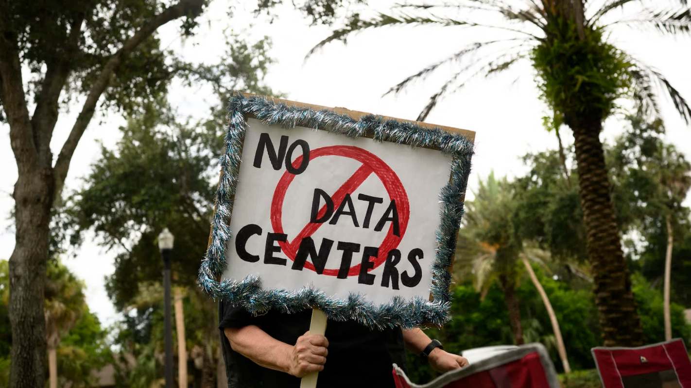 A protester holding an anti-data center sign.