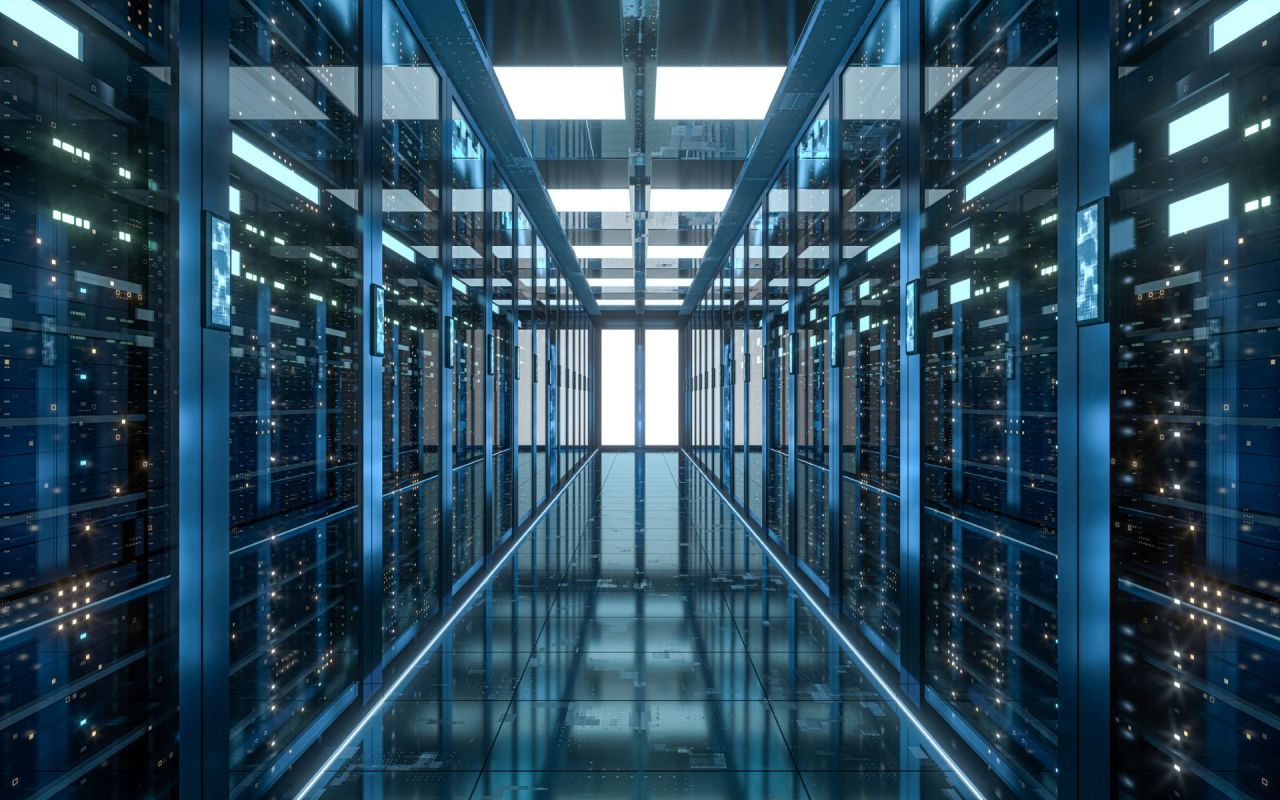 A long corridor between rows of illuminated server racks in a high-tech data center.