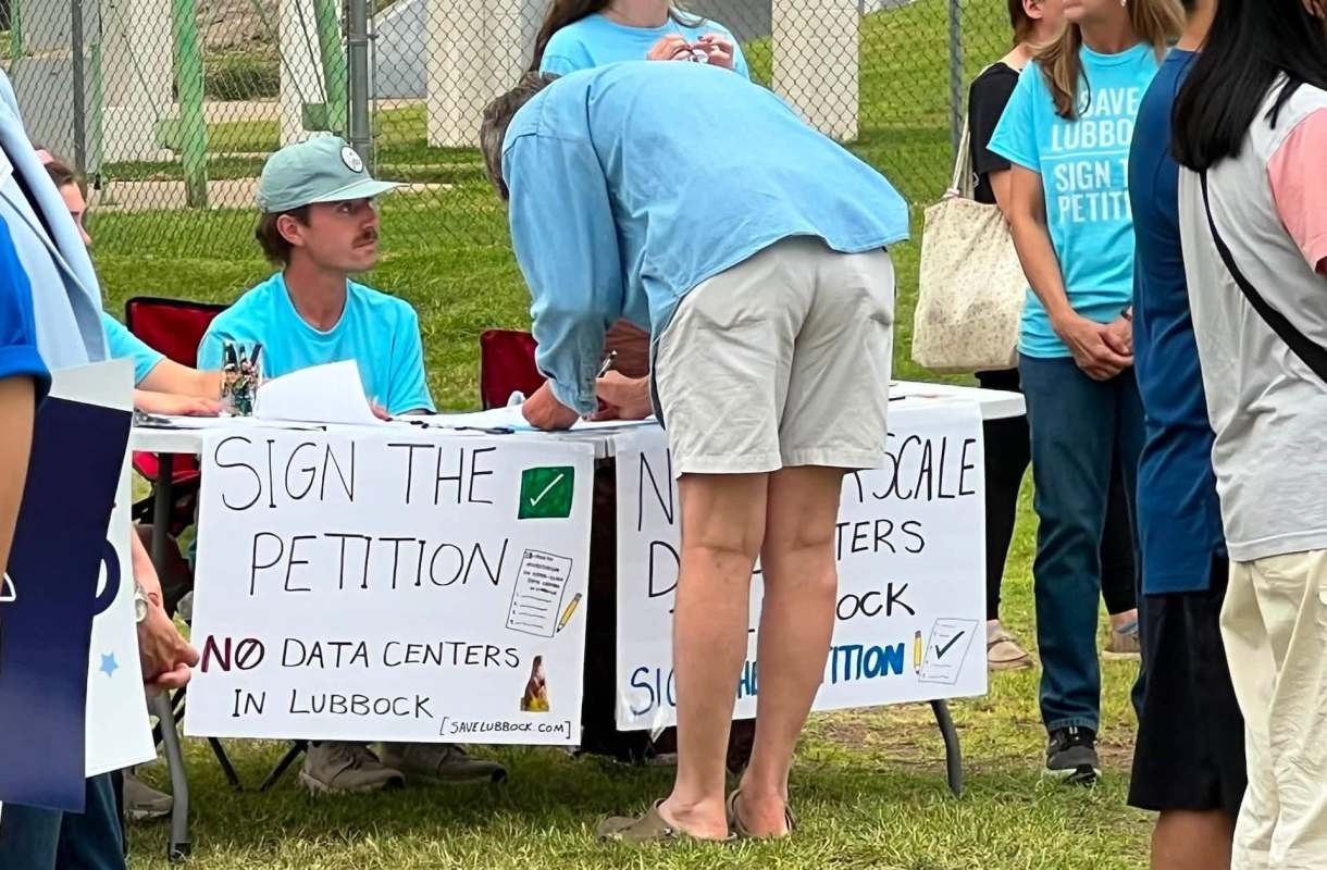 People signing a petition to keep data centers out of Lubbock, Texas.