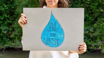 A person holding a "Save Our Water" sign.