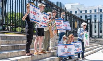 Protesters holding signs opposing tax breaks for data centers.