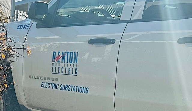A close-up of a white pickup truck with "Denton Municipal Electric" and "Electric Substations" printed on the side.