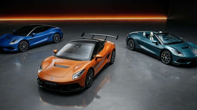 Three luxury sports cars in a showroom: an orange coupe, a blue coupe, and a teal convertible, all under dramatic lighting.