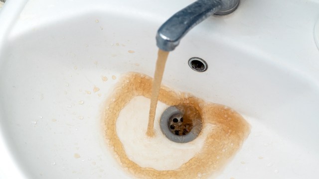 Brown water out of a faucet.
