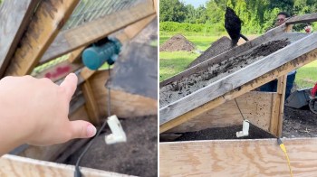 A person points at a mechanism in a wooden structure with dirt and a person nearby.