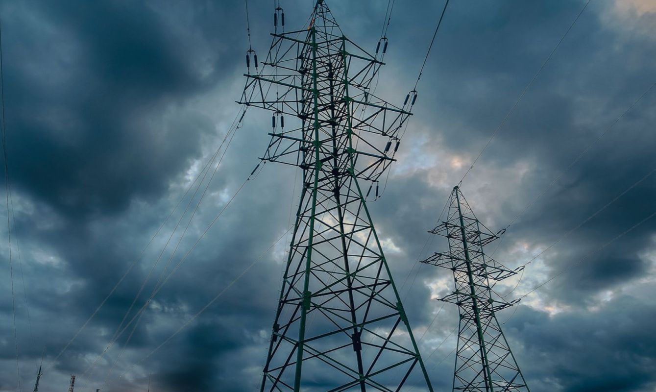 Electric towers under a stormy sky.