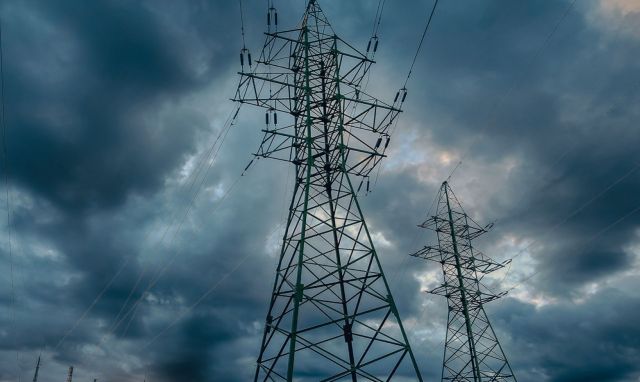 Electric towers under a stormy sky.