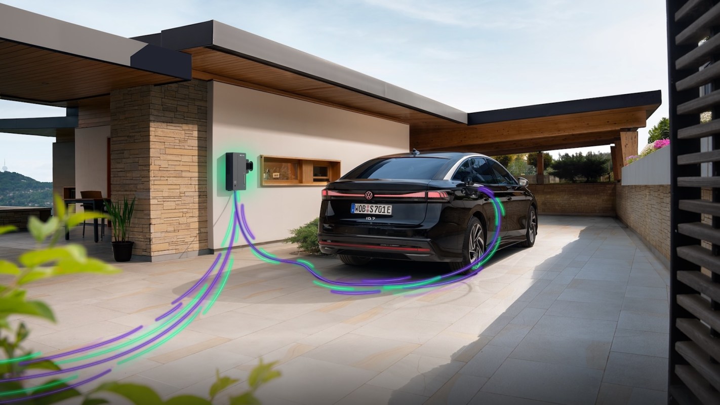 A black electric car is charging at a home charging station with green and purple lines representing charging.