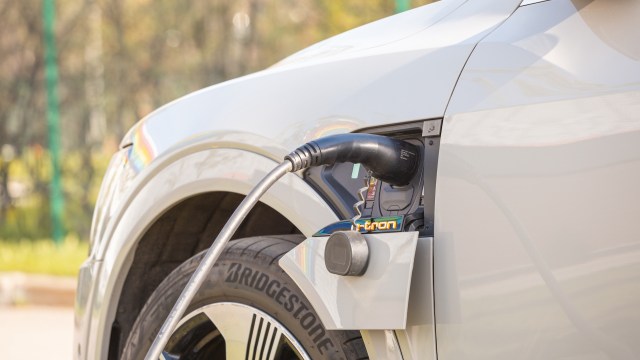 An electric vehicle with a charging cable attached.