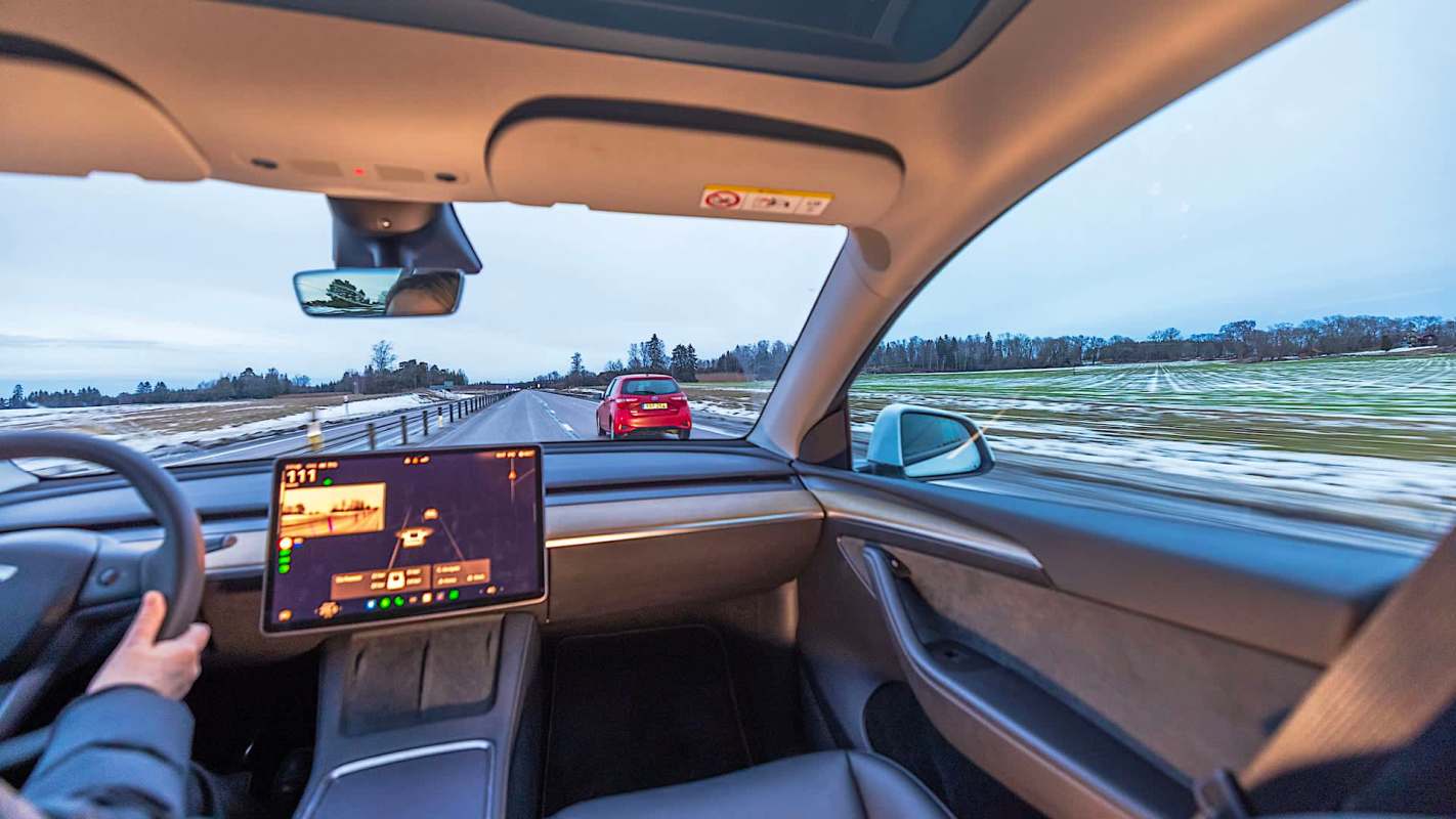 A driver navigating a road in winter.
