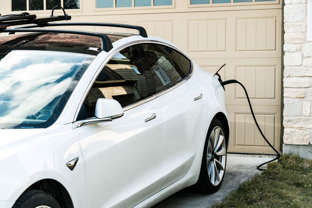 An EV plugged in and charging at home.