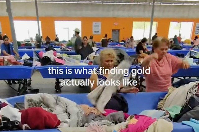 People looking through bins of clothing.