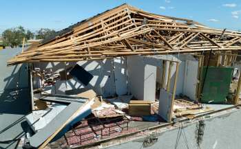 A building with a collapsed roof and exposed interior.