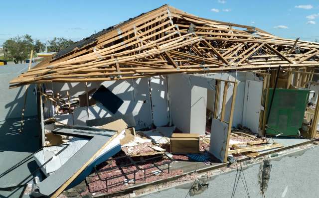 A building with a collapsed roof and exposed interior.