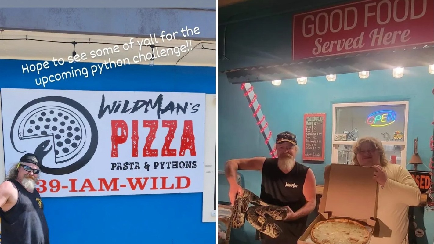 A man with a snake poses next to a person holding a pizza in front of Wildman's Pizza restaurant.