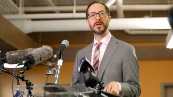 Nashville mayor Freddie O'Connell speaks at a podium with microphones during a press conference.