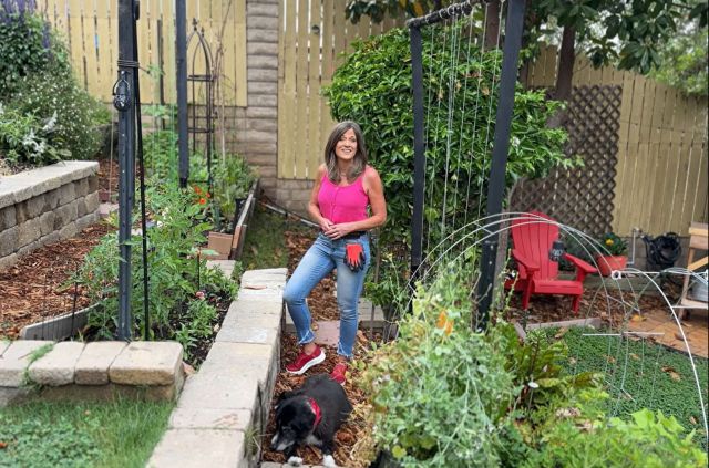 A woman standing in a garden.