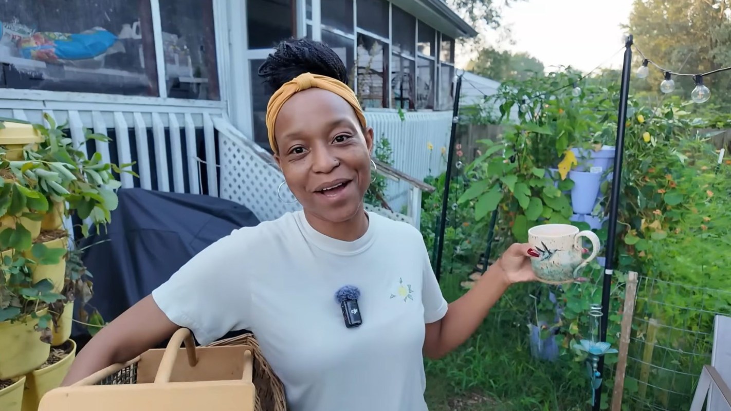 A woman standing in her garden.