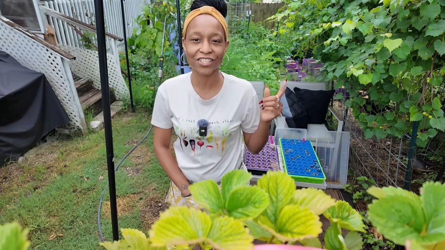 A woman standing in a garden.