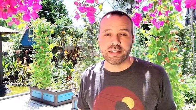 Brian Lowell standing in a garden.