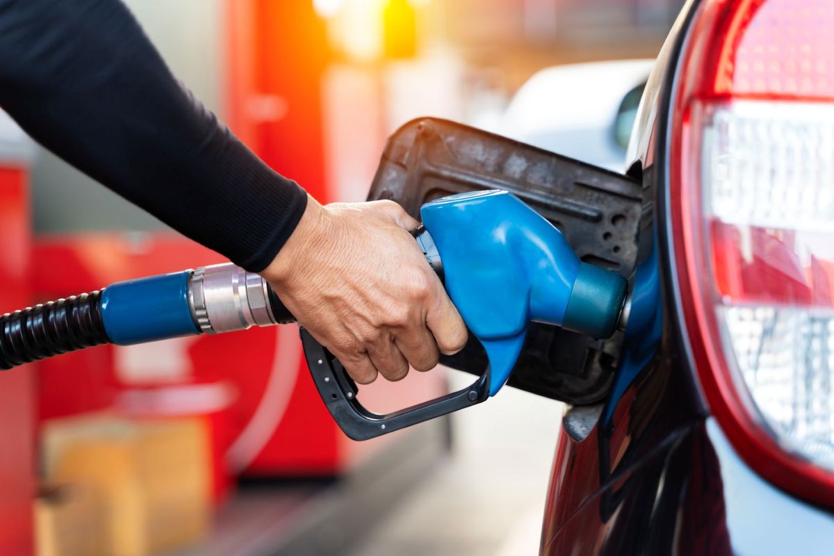 A person pumping gas into their car.