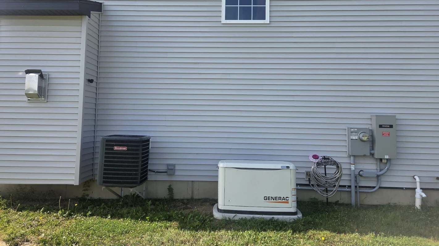 A side view of a house featuring an air conditioning unit and a generator next to utility connections on the wall.