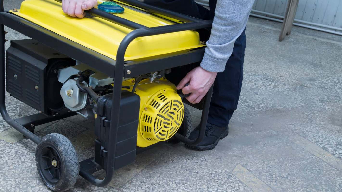 A person starting a yellow generator.