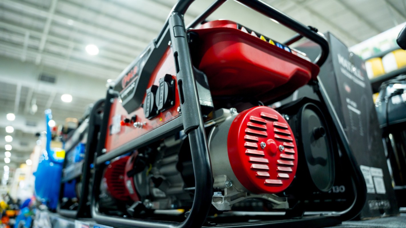 A red and black portable generator in a retail store.