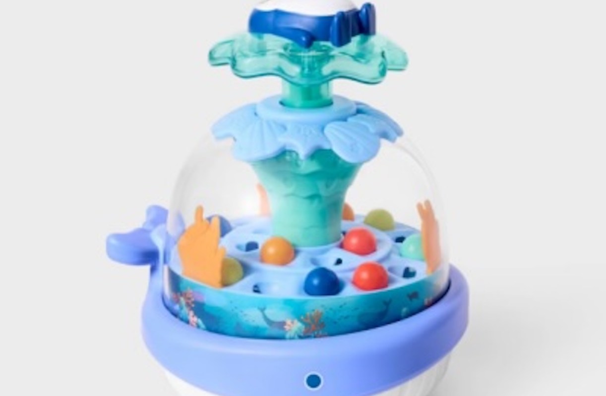 A whale-shaped toy featuring colorful balls inside a dome.