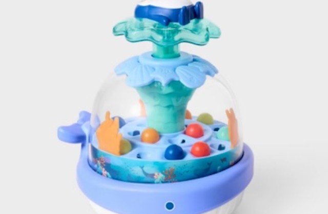 A whale-shaped toy featuring colorful balls inside a dome.