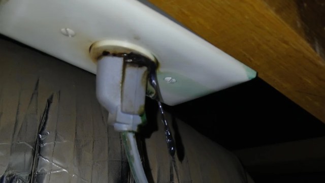 A leaking electrical outlet with discolored areas around the socket.