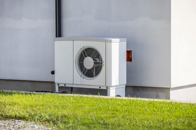 An outdoor HVAC unit near grass.