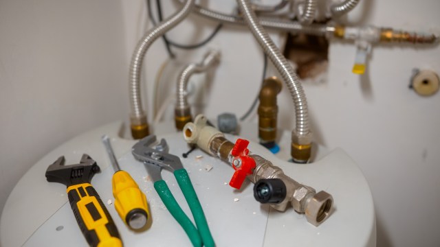 Plumbing tools on top of a water heater.