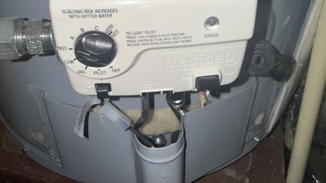 A water heater control panel with settings for temperature and pilot light instructions.