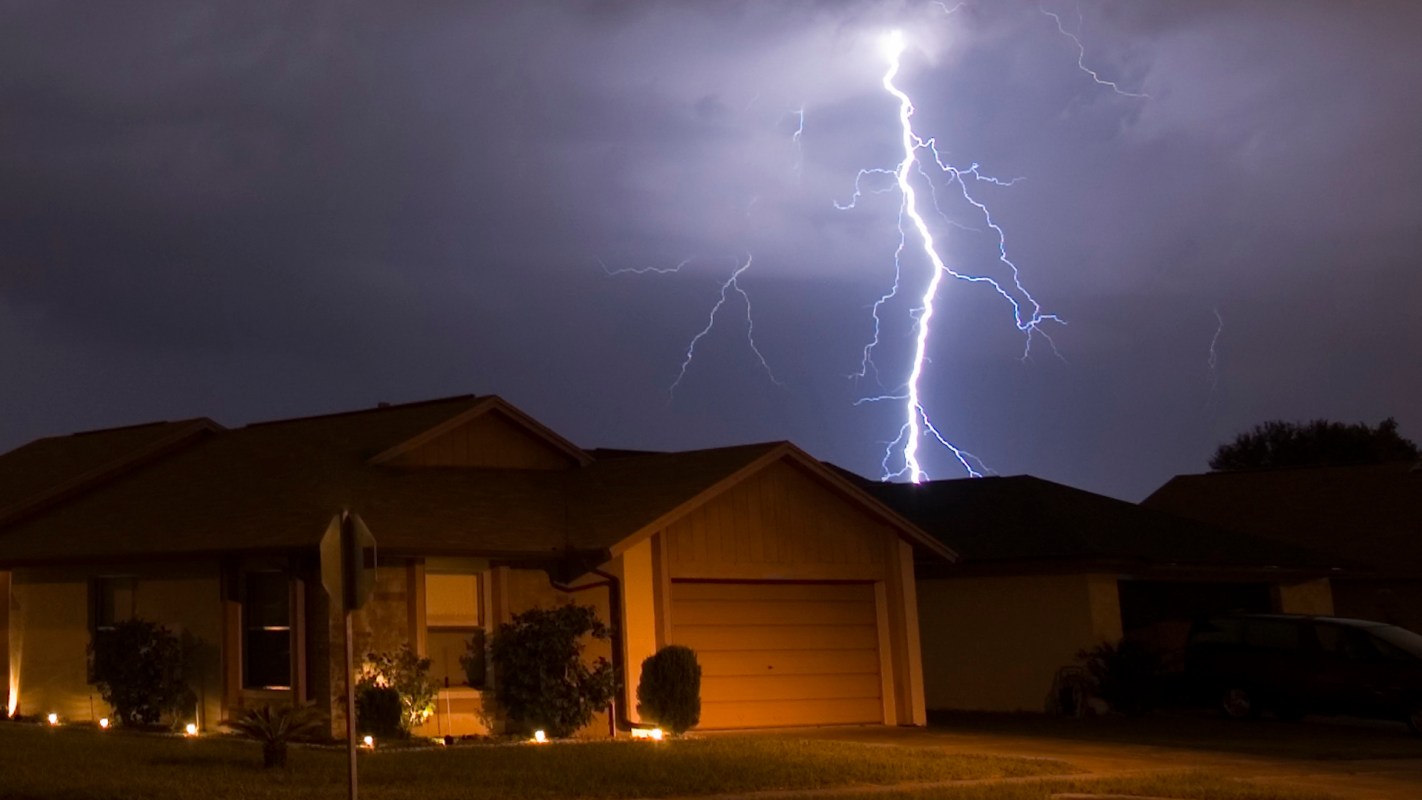 A lightning strike near a residential neighborhood.
