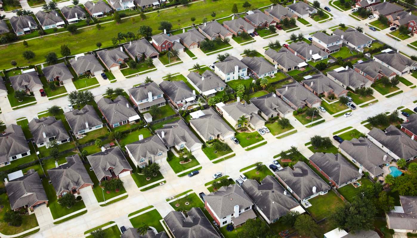 A suburban neighborhood with manicured green lawns.