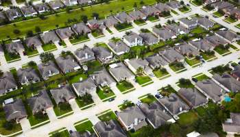 A suburban neighborhood with manicured green lawns.