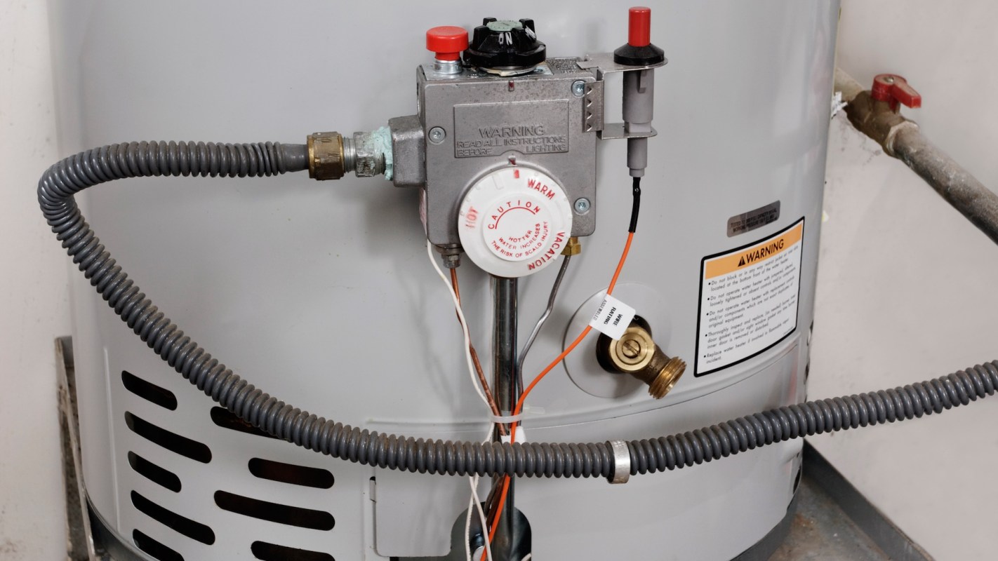 Water temperature controls on the side of a water heater.