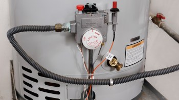 Water temperature controls on the side of a water heater.